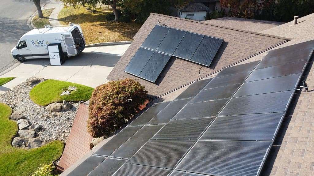 Image of rooftop with solar panels and Solar Negotiators van. 
