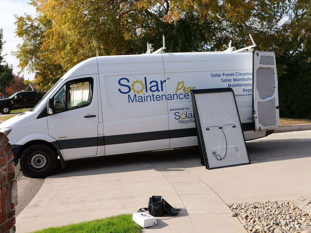 Image of a Negotiators van with solar panels on the side of it. 